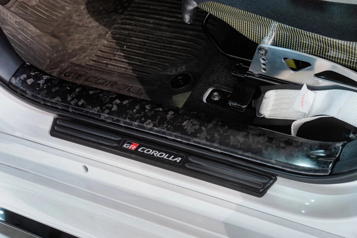 TOM'S Racing [23 - 26 GR Corolla, 19 - 26 Corolla Hatchback] Forged Carbon Front Scuff Plate Cover | TMS - 67913 - TEA14 - JDMuscleTrim KitstmsTMS-67913-TEA14